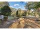 Spacious backyard with mature trees and a large grassy area at 2081 Dodson Sw Dr, Atlanta, GA 30311