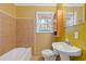 Bathroom with neutral tile, a pedestal sink, and a tub at 2081 Dodson Sw Dr, Atlanta, GA 30311