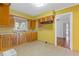 Kitchen with wood cabinets, yellow walls, and tile flooring at 2081 Dodson Sw Dr, Atlanta, GA 30311