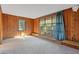 Living room with wood paneling, built-in seating and large windows at 2081 Dodson Sw Dr, Atlanta, GA 30311