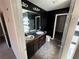 Bathroom with dark vanity and double sinks at 2754 Topaz Rd, Riverdale, GA 30296