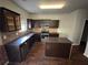 Kitchen with dark cabinets, granite counters and island at 2754 Topaz Rd, Riverdale, GA 30296