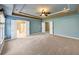 Main bedroom with high ceilings, carpet, and ceiling fan at 4203 Moccasin Trl, Woodstock, GA 30189