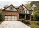 Two-story home with a three-car garage and manicured lawn at 2725 Monet Dr, Cumming, GA 30041