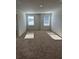 Spacious bedroom with neutral carpeting and large windows at 504 Overlook Rd, Covington, GA 30052