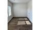 Bright bedroom with neutral walls, wood-look flooring, and window with blinds at 504 Overlook Rd, Covington, GA 30052