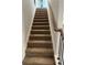 Carpeted staircase with dark wood railing at 504 Overlook Rd, Covington, GA 30052