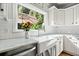 Kitchen features white cabinets, marble countertops, and a farmhouse sink at 212 Briarwood Ln, Canton, GA 30114