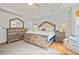 Main bedroom with king bed, hardwood floors, and a fireplace at 212 Briarwood Ln, Canton, GA 30114