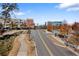 View of a tree-lined street with modern buildings and ample parking at 138 Reddington Pl, Atlanta, GA 30328