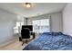 Well-lit bedroom featuring a bed and workspace at 3431 Tioga Lake Cv, Lawrenceville, GA 30044