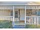 Inviting front porch with white railings and stone accents at 3109 Meadow Wood Ct, Lawrenceville, GA 30044