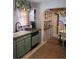 Kitchen with green cabinets, and a dining area with yellow chairs at 710 Windsor Ter, Avondale Estates, GA 30002