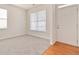 Spacious living room with neutral carpeting and large window at 7370 Gossamer St, Union City, GA 30291