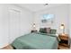 Cozy bedroom with a green duvet, wood floors, and ample closet space at 2211 Macon Sw Dr, Atlanta, GA 30315