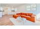 Bright living room featuring a burnt orange sectional sofa and wood-look flooring at 2211 Macon Sw Dr, Atlanta, GA 30315