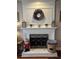 White brick fireplace with decorative wreath and lanterns at 1025 Charleston Trce, Roswell, GA 30075