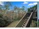 Stairs leading up to a deck with wooded views at 1497 Tribble Run Dr, Lawrenceville, GA 30045