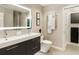 Modern bathroom with double sinks and a lit mirror at 20 Pointe Se Ter, Atlanta, GA 30339