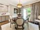 Charming dining room with round table, chandelier, and gray chairs at 20 Pointe Se Ter, Atlanta, GA 30339