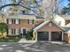 Brick home with two-car garage and landscaped lawn at 20 Pointe Se Ter, Atlanta, GA 30339