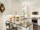 Modern kitchen with white cabinets, granite countertops, and stainless steel appliances at 20 Pointe Se Ter, Atlanta, GA 30339