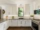 Modern kitchen with white cabinets, granite countertops, and stainless steel appliances at 20 Pointe Se Ter, Atlanta, GA 30339