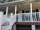 Inviting front porch with white railings and a brown deck at 5880 Yardley Ct, Powder Springs, GA 30127