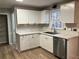 Modern kitchen with white shaker cabinets, quartz countertops, and stainless steel appliances at 5880 Yardley Ct, Powder Springs, GA 30127