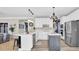 Updated kitchen featuring white cabinetry, a large island, and stainless steel appliances at 6705 Brookline Ct, Cumming, GA 30040