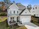 Two-story house with gray siding, white trim, and a two-car garage at 1834 Grand Oaks Ln, Woodstock, GA 30188