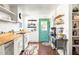 Bright kitchen features butcher block countertops, stainless steel appliances, and a charming teal door at 490 Gift Ave, Atlanta, GA 30316