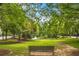 Relaxing park bench overlooking a peaceful pond and lush green space at 390 17Th Nw St # 4003, Atlanta, GA 30363