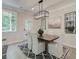 Elegant dining room with a wood table, chandelier, and neutral decor at 273 Dahlia Dr, Woodstock, GA 30188