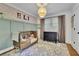 Charming bedroom with wood crib, dresser, and patterned rug at 335 Brook Dr, Atlanta, GA 30328