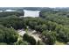 Aerial view of lakefront community with tennis court and a pool at 3200 Rim Cove Dr # 186, Cumming, GA 30041