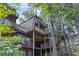 Another view of the elevated home among the trees at 3200 Rim Cove Dr # 186, Cumming, GA 30041