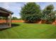 Spacious backyard with large tree and wooden fence at 4655 Cabrini Pl, Cumming, GA 30028