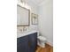 Small bathroom with dark vanity and white toilet at 108 Cottage Gate Ln, Roswell, GA 30076