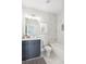 Bathroom with dark vanity, marble shower, and white toilet at 108 Cottage Gate Ln, Roswell, GA 30076