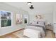 Bright bedroom with hardwood floors and window views at 108 Cottage Gate Ln, Roswell, GA 30076