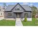 Gray farmhouse exterior with a stone path and lush green lawn at 108 Cottage Gate Ln, Roswell, GA 30076