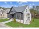 Two-toned farmhouse with gray and white siding, stone path, and landscaping at 108 Cottage Gate Ln, Roswell, GA 30076
