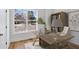 Home office with large window, wood desk, and built-in bookcase at 108 Cottage Gate Ln, Roswell, GA 30076