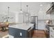 Modern kitchen with island, stainless steel appliances, and hardwood floors at 108 Cottage Gate Ln, Roswell, GA 30076