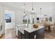 Bright kitchen with farmhouse sink, island, and view from window at 108 Cottage Gate Ln, Roswell, GA 30076