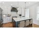 Modern kitchen with white cabinets, dark island, and stainless steel appliances at 108 Cottage Gate Ln, Roswell, GA 30076
