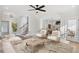 Open living room with hardwood floors, neutral decor, and access to kitchen at 108 Cottage Gate Ln, Roswell, GA 30076