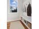 White mudroom with bench, storage, and coat hooks at 108 Cottage Gate Ln, Roswell, GA 30076