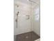 Modern shower with hexagon tile floor and frameless glass enclosure at 108 Cottage Gate Ln, Roswell, GA 30076